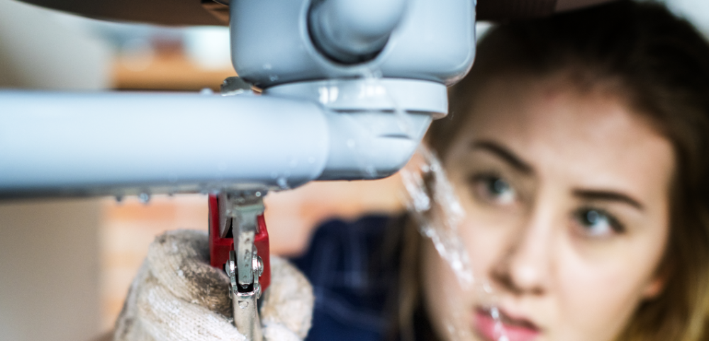 a woman trying to fix a plumbing issue after her home warranty expired