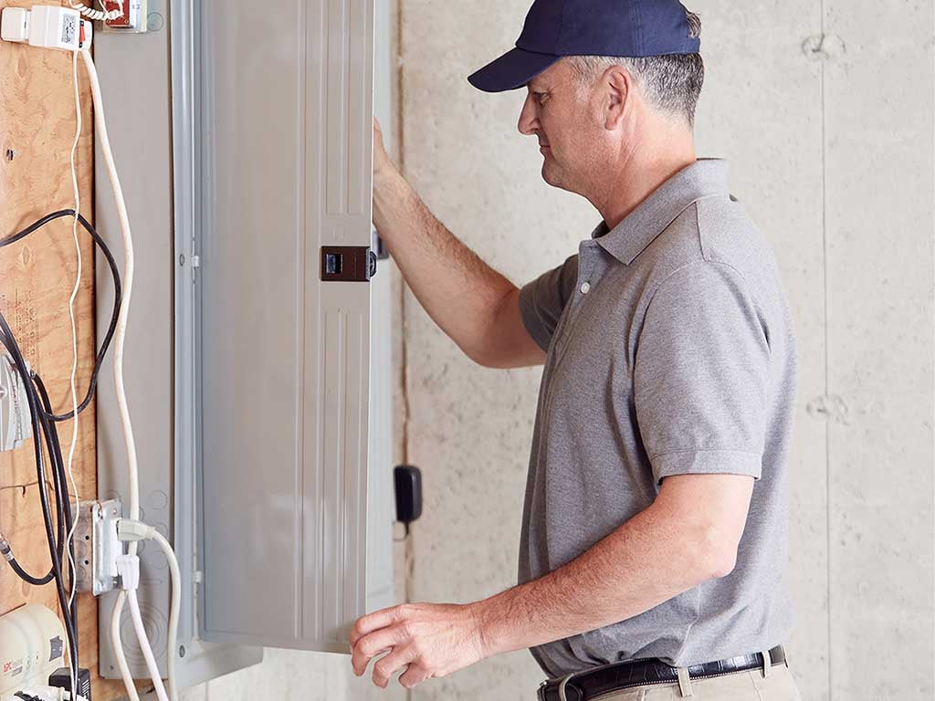 Electrician inspecting circuit board