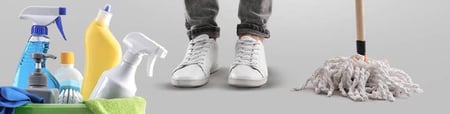 Person with white shoes stands behind cleaning supplies