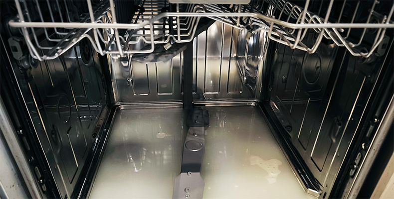 a dishwasher with dirty water inside