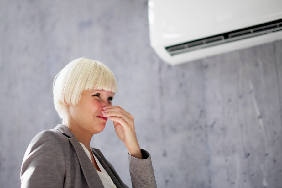 woman smelling bad air from hvac